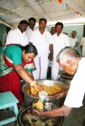The political leader of the district distribut the meal to the students