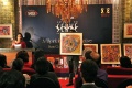 Mahitha talking about the paintings and the artists