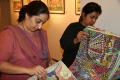 Darshan Shah (on the right), owner of the gallery, looking through the pile of Bindu art