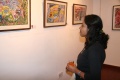 Woman looking at Aramugams painting