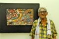 Eswaran stands proud in front of his painting