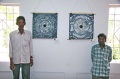 Kumar and Balachandran in front of their paintings