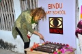 Tia Pleiman cutting the Bindu birthday cake