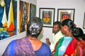 Bindu-Students discussing the displayed paintings