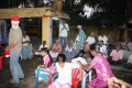 Rahuel as Santa Claus plays a children game with the young artists.