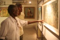 Subiah and Veerasamy discussing some details of a painting