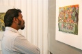 An artist looks at a Bindu-painting