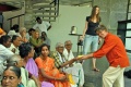 The guests interact with our students by giving them pieces of the birthday cake