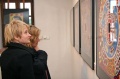 Visitors looking at the paintings