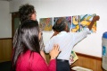 Babu Ramachandran mounts a painting on the wall