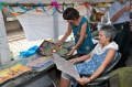 Visitors of Bindu-Art School looking through a pile of paintings