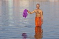Ramachandran dips the sari of his wife in the Ganga, because she can