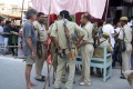 Werner discussing with the police to get the students in the temple without queuing..